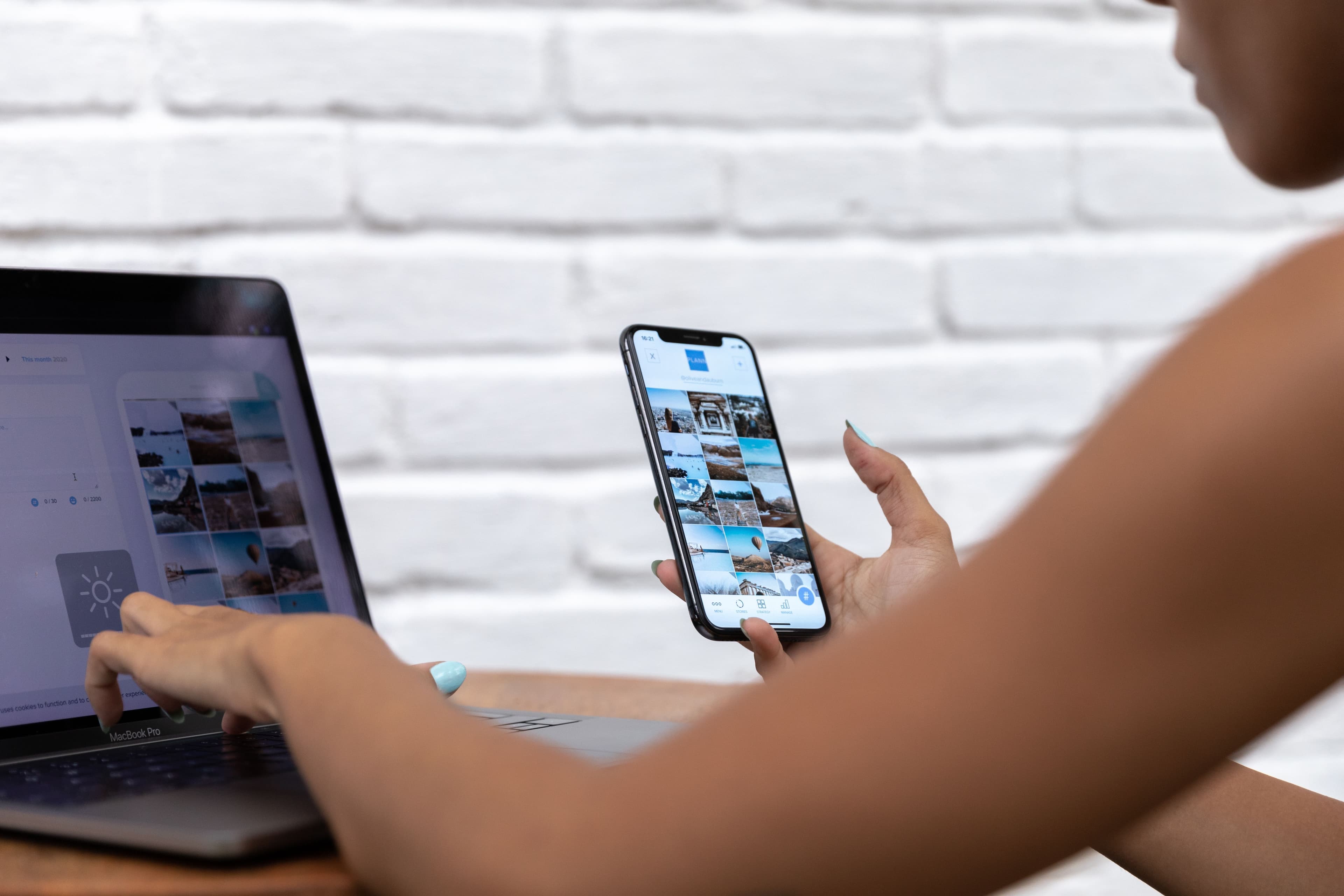 Creator planning social media content on a phone and laptop
